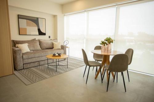 a living room with a couch and a table and chairs at MrW Incredible loft in Livify in Guadalajara