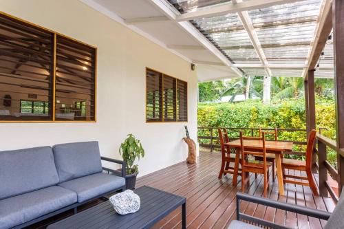 a living room with a couch and a table at Surfsidelodge in Cabo Matapalo