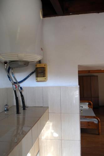 a room with a counter with a clock on the wall at Ioannis Home at Skonizo in Chania Town
