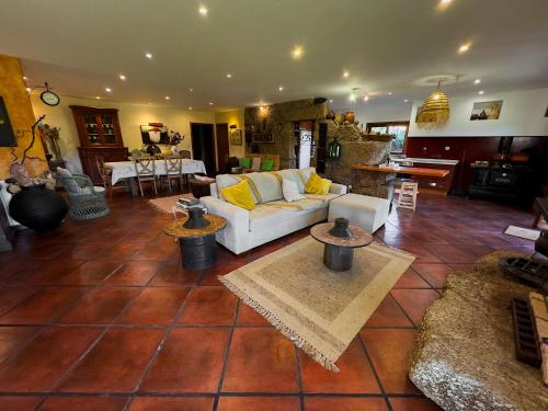 a living room with a white couch on a tile floor at Olival House in Paço de Sousa