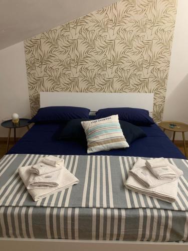 a bed with blue sheets and towels on it at Casa del sole in Nova Siri Marina