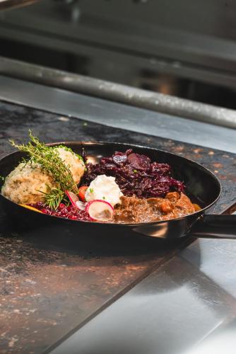 a pan of food sitting on top of an oven at Schallerhof in Neustift im Stubaital