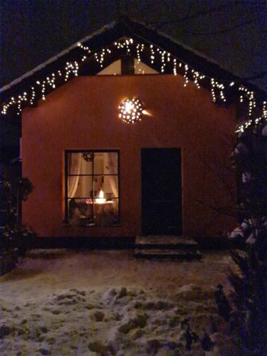 a house with christmas lights on it at night at Vila Šventoji in Šventoji