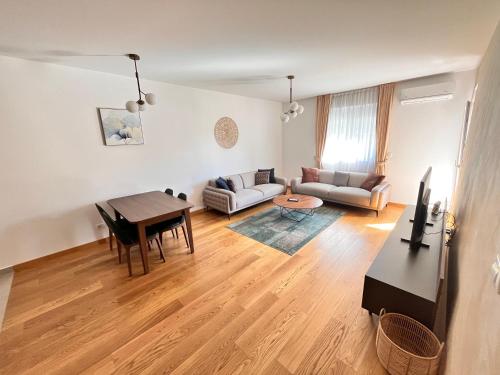 a living room with a couch and a table at New City Luxury Apartments in Podgorica
