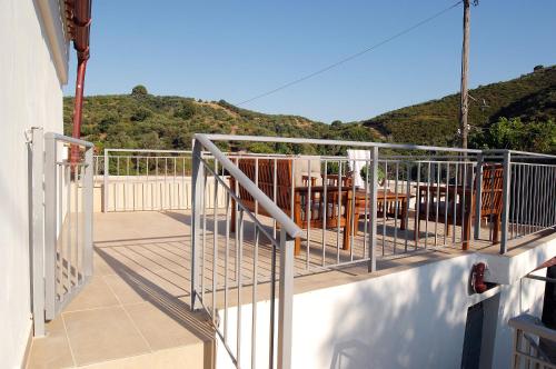 a balcony with chairs and tables on a house at Ioannis Home at Skonizo in Chania Town