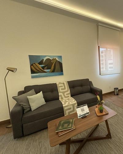 a living room with a couch and a coffee table at Casa Herrmann Suites in Mexico City