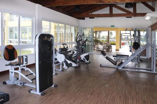 a gym with a lot of treadmills and machines at Apartamento em condomínio com passeio incluso in Baixio