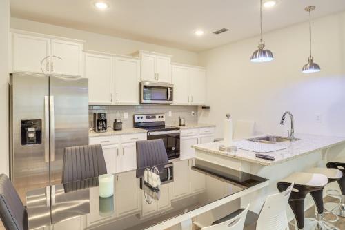 a kitchen with white cabinets and stainless steel appliances at Family-Friendly Townhome in Murfreesboro! in Murfreesboro
