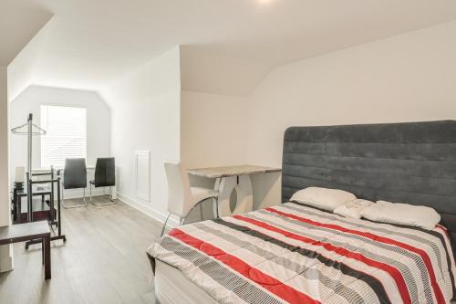 a bedroom with a bed and a table and chairs at Family-Friendly Townhome in Murfreesboro! in Murfreesboro