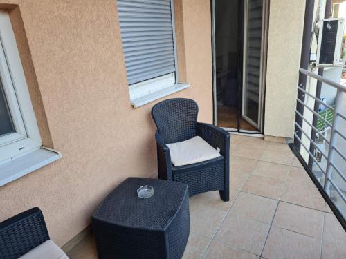 a balcony with a chair and a table at Apartment California in Brčko