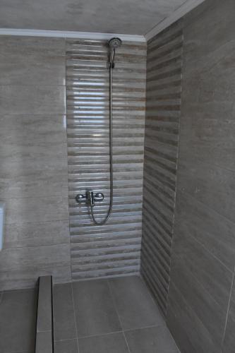 a shower with a glass door in a bathroom at Ioannis Home at Skonizo in Chania Town