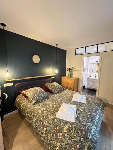 a bedroom with a bed with two books on it at The Little Studio in Strasbourg