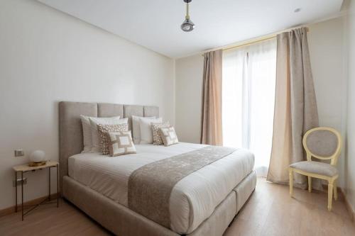 a bedroom with a large bed and a window at Luxury Eagle Hills Apartment in Rabat