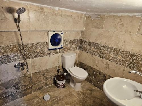 a bathroom with a toilet and a sink at Cozy and lovely studio in Cairo