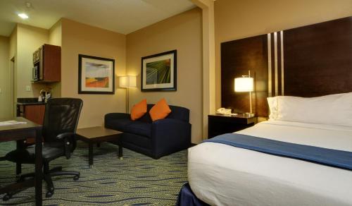 a hotel room with a bed and a desk and a chair at Holiday Inn Express & Suites Midwest City, an IHG Hotel in Midwest City