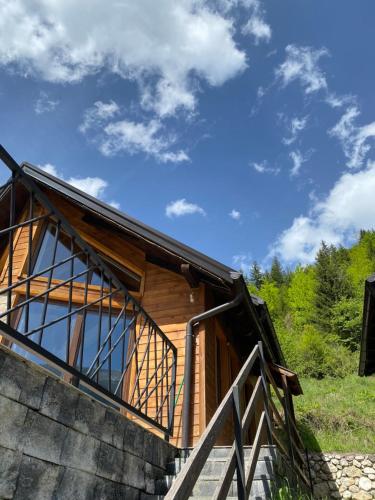 a wooden cabin with a staircase leading up to it at Fisi Resort in Peje