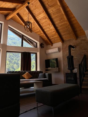 a living room with a couch and a tv at Fisi Resort in Peje