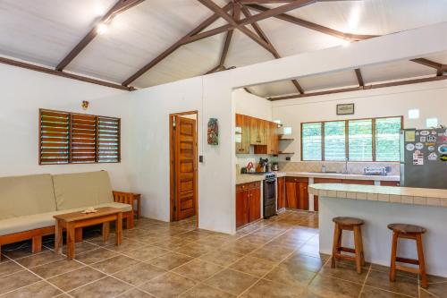 a kitchen and living room with a couch and a table at Surfsidelodge in Cabo Matapalo