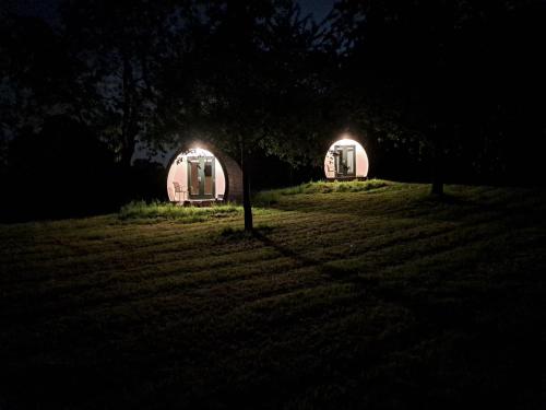 a couple of tents in a field at night at B&B Uit de Kunst APPEL in Bingelrade