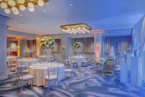 a banquet hall with white tables and chairs and flowers at Le Meridien Washington, DC, The Madison in Washington