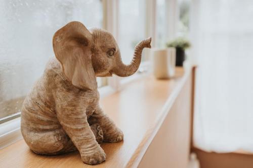 a small elephant figurine sitting on a floor at The Grove in Lawley Bank