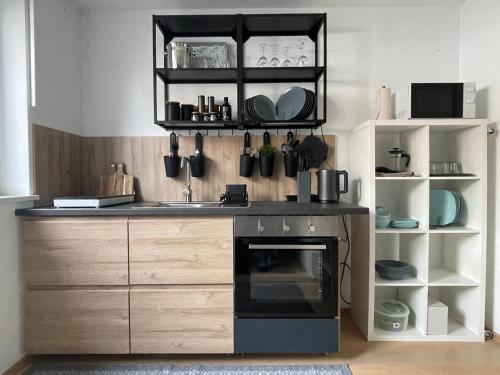 a kitchen with a sink and a stove at 80qm Appartement, 3 Schlaf-Zimmer, integrierter Küche und Bad, 2min von A8, Garten mit Sitzgruppe, ruhig und modern in Irschenberg