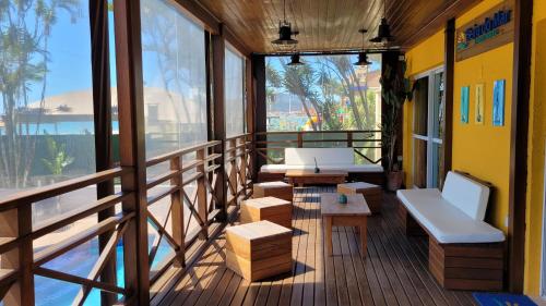 a balcony with benches and tables on a building at Apart Hotel Beira do Mar in Florianópolis