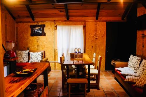 a dining room with a wooden table and chairs at Tombstone in Valle de Bravo