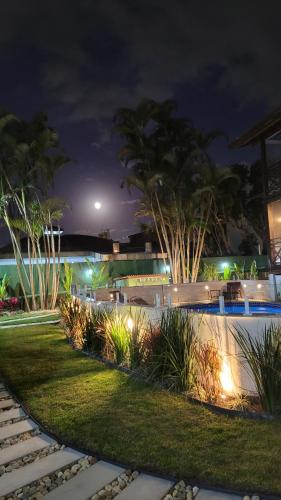 a resort yard at night with lights and plants at Apart Hotel Beira do Mar in Florianópolis