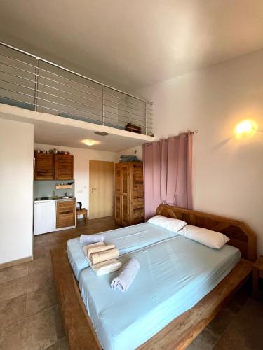 a bedroom with a large bed with towels on it at Bajic Apartmani in Seline