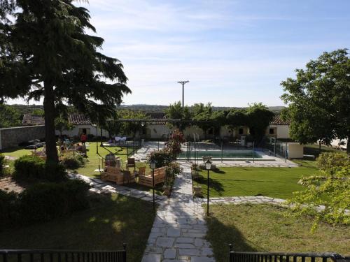 a view of a park with a playground at CASA RURAL PALACIO CONDE DE ALDANA con piscina entre encinares y dehesas in Terradillos