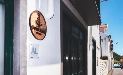 a sign on the side of a building at Guest House Genuíno in Horta