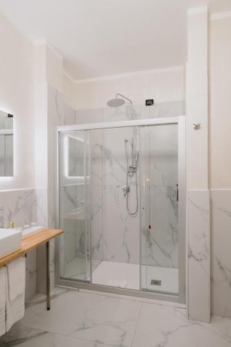 a shower with a glass door in a bathroom at Alatea Porta Nuova 20 in Verona