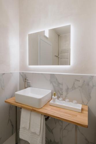 a bathroom with a white sink and a mirror at Alatea Porta Nuova 20 in Verona