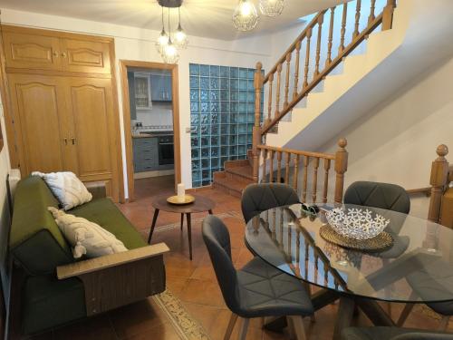 a living room with a glass table and chairs at Martínez Suite Burgos in Burgos