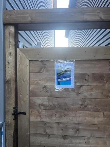 a wooden door with a sign taped to it at Adorable Private Suite in Seton SE, Calgary in Calgary