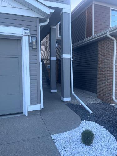 a house with a garage and a driveway at Adorable Private Suite in Seton SE, Calgary in Calgary