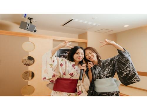 two women posing for a picture in a mirror at Tokigasane - Vacation STAY 15860v in Kaga