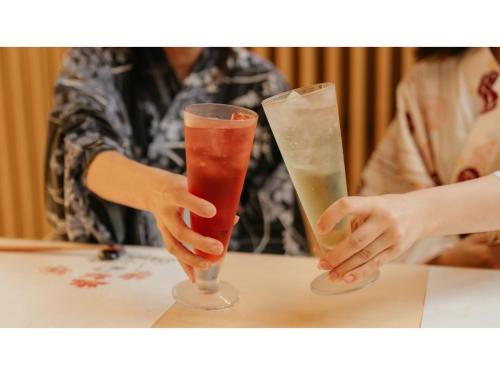 two people sitting at a table with two drinks at Tokigasane - Vacation STAY 15860v in Kaga