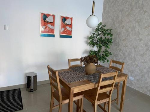 a dining room table with a potted plant on it at Residencial Marilopez in Punta Cana