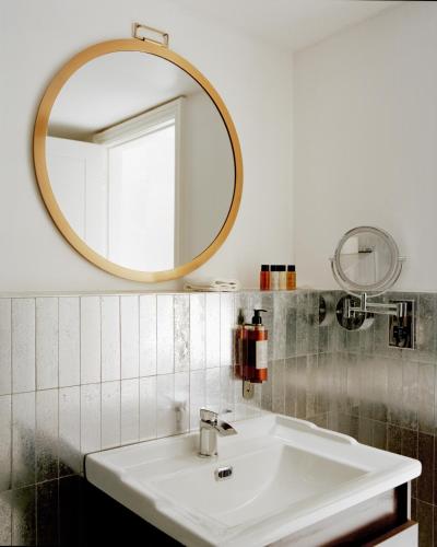 a bathroom with a sink and a mirror at Trueman Court Luxury Serviced Apartments in Liverpool