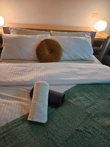 a bed with a pillow and a towel on it at Chic Town House in Melbourne