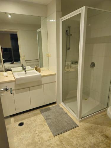 a bathroom with a shower and a sink and a shower at Chic Town House in Melbourne