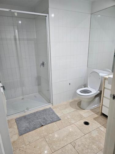 a bathroom with a shower and a toilet at Chic Town House in Melbourne
