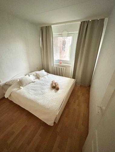 a bedroom with a bed with a teddy bear on it at K&A apartament in Haapsalu
