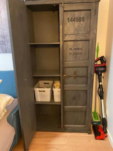 a gray cabinet with shelves and tools in a room at Studio-Apartment Weimar in Weimar
