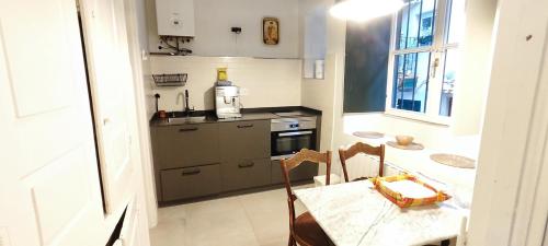 a small kitchen with a table and a bottle of wine at Mundaka Old town in Mundaka