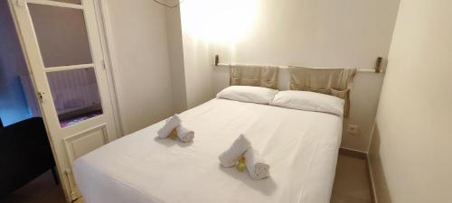 a small white bed with two towels on it at Mundaka Old town in Mundaka