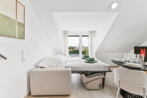 a bedroom with a bed and a table and chairs at The Serviced - Design Apartments in Stuttgart