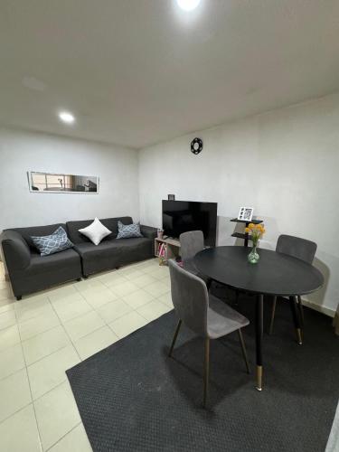 a living room with a table and a couch at Apartamento para 4 personas CDMX in Mexico City